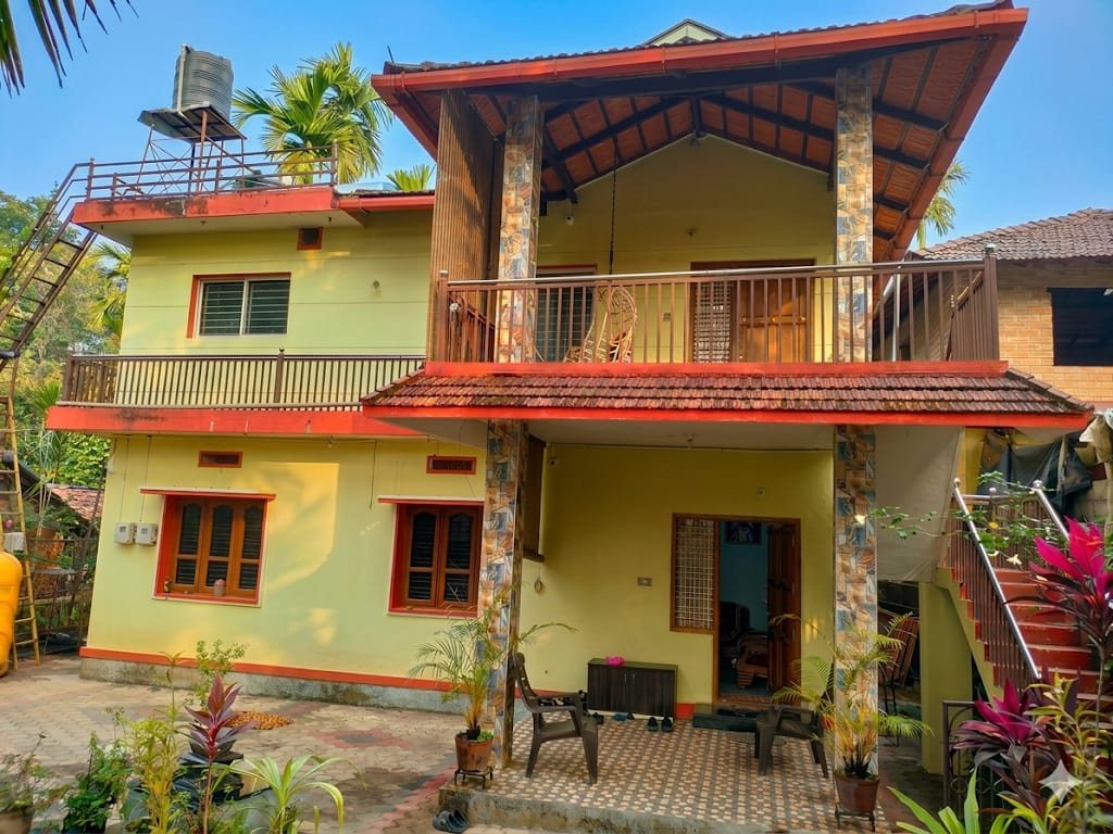 ANVAM Homestay exterior with tiled roof and garden